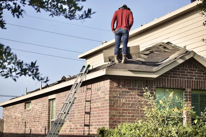 Professional roofer working on a residential roof in Feurborn Klodes Arlington Manor